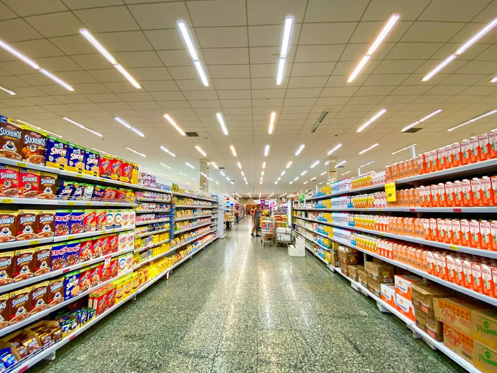 Interior of a U.S. military commissary showing brightly lit stocked grocery aisles