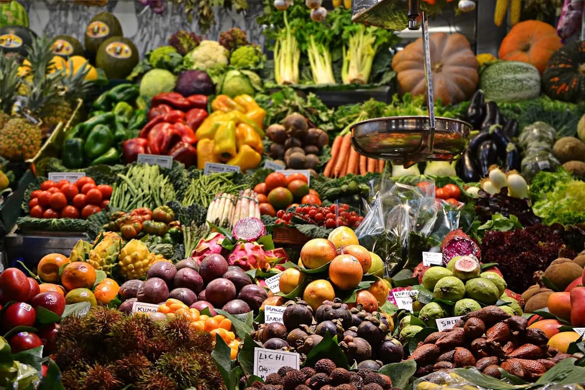 Abundant fresh produce display with colorful fruits and vegetables in a commissary grocery section